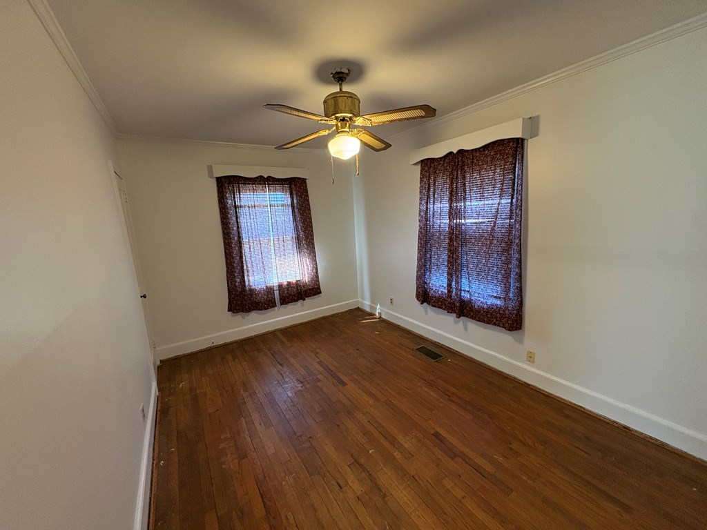 2534 Cole Drive Columbus, GA 31906 - Photo 14 of 18 an empty room with wooden floor chandelier fan and windows