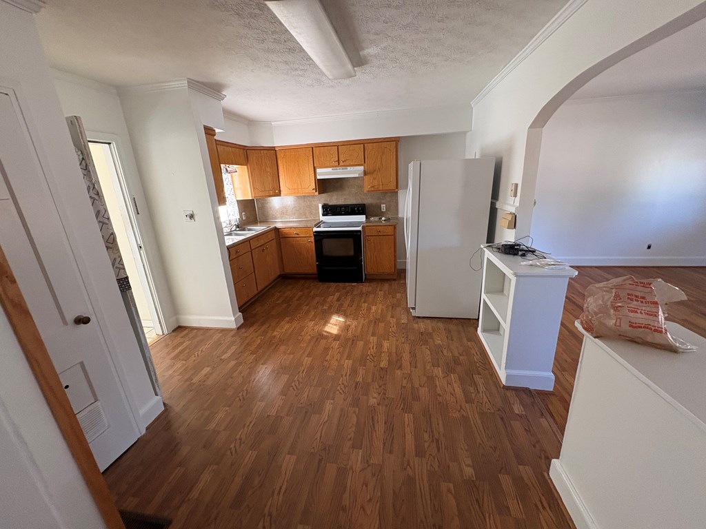 2534 Cole Drive Columbus, GA 31906 - Photo 7 of 18 a kitchen with a wooden floor a sink and a stove