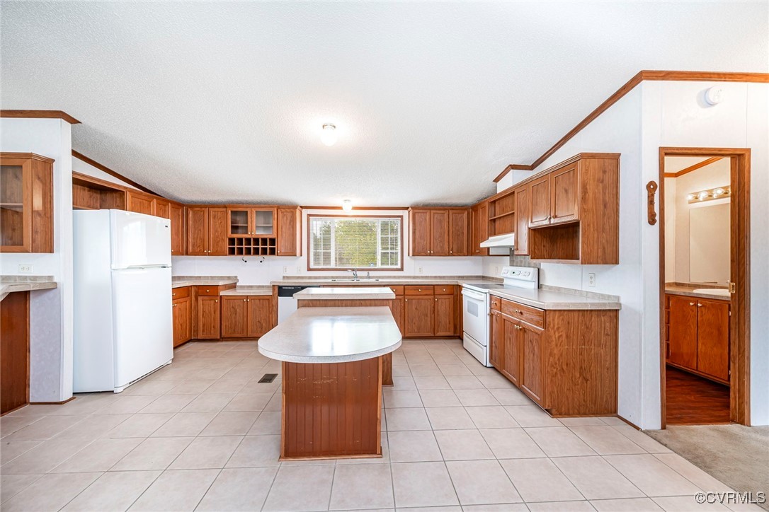 394 Tower Road Brodnax, VA 23920 - Photo 8 of 34 a large kitchen with stainless steel appliances kitchen island granite countertop a refrigerator a sink dishwasher and white cabinets with wooden floor