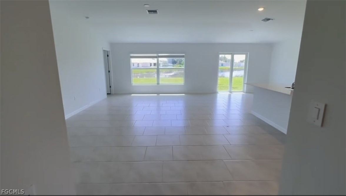 12312 Amber Waves Road Lehigh Acres, FL 33974 - Photo 14 of 32 a view of an empty room with a window and wooden floor