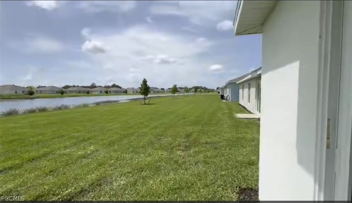 12312 Amber Waves Road Lehigh Acres, FL 33974 - Photo 17 of 32 a view of a water fountain and a big yard
