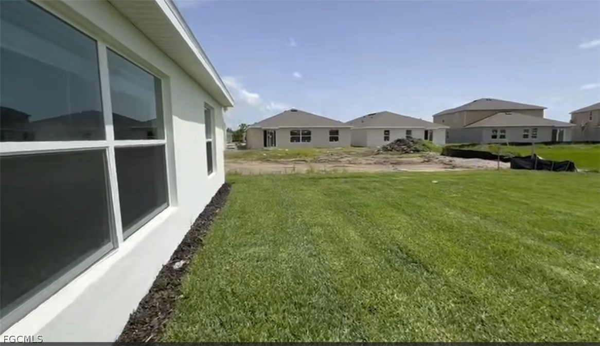 12312 Amber Waves Road Lehigh Acres, FL 33974 - Photo 18 of 32 a house view with a garden space