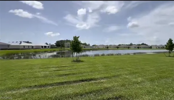 a view of a lake with houses in the back
