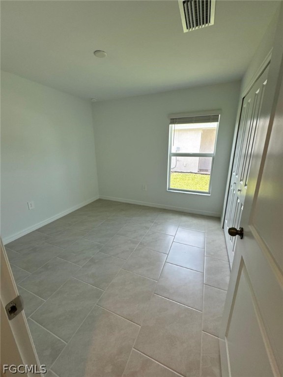 12312 Amber Waves Road Lehigh Acres, FL 33974 - Photo 22 of 32 a view of an empty room with a window
