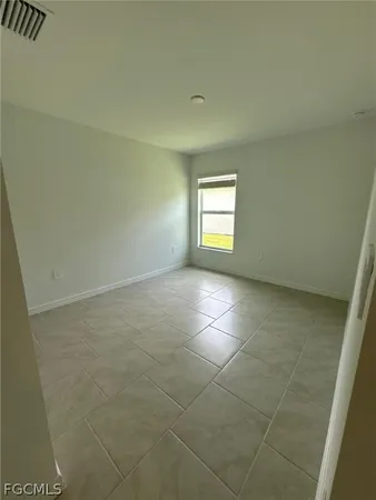 a view of an empty room and a window