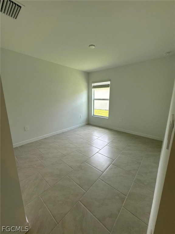 12312 Amber Waves Road Lehigh Acres, FL 33974 - Photo 23 of 32 a view of an empty room and a window