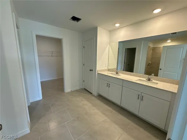 a bathroom with a double vanity sink and a mirror