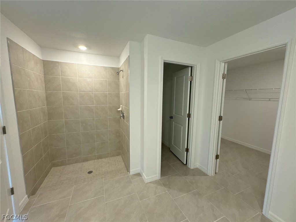 12312 Amber Waves Road Lehigh Acres, FL 33974 - Photo 26 of 32 a bathroom with a shower