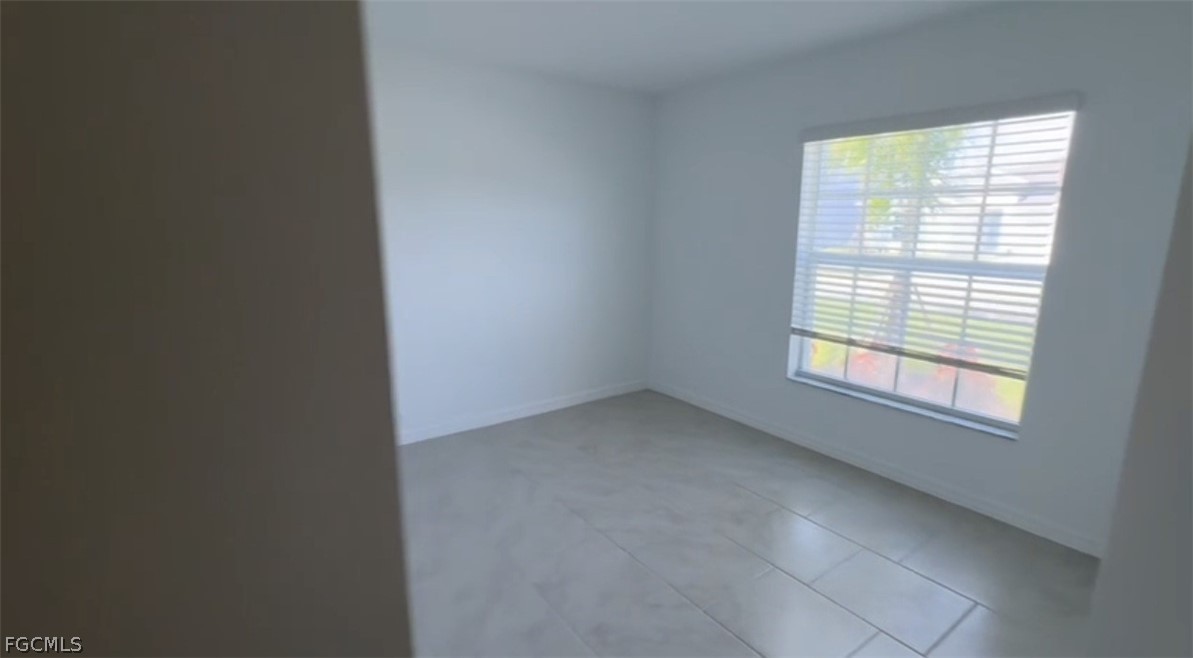 12312 Amber Waves Road Lehigh Acres, FL 33974 - Photo 5 of 32 an empty room with a window