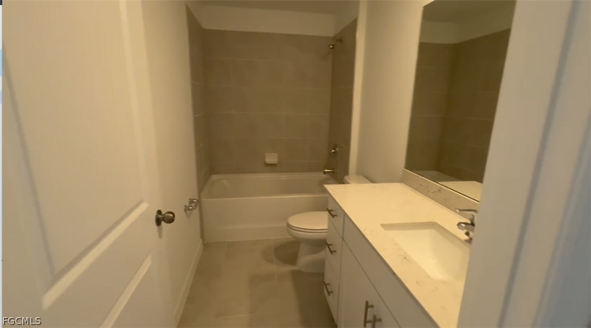 12312 Amber Waves Road Lehigh Acres, FL 33974 - Photo 6 of 32 a bathroom with a sink a toilet and shower