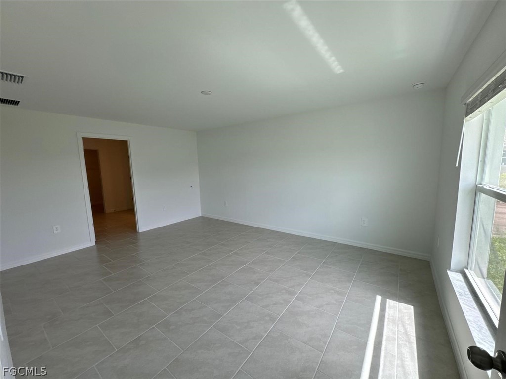 12312 Amber Waves Road Lehigh Acres, FL 33974 - Photo 9 of 32 an empty room with windows