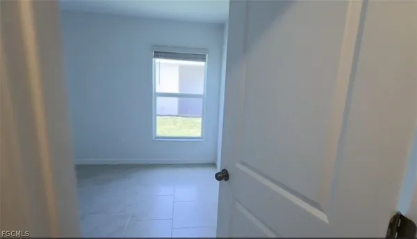 a view of an empty room and a window