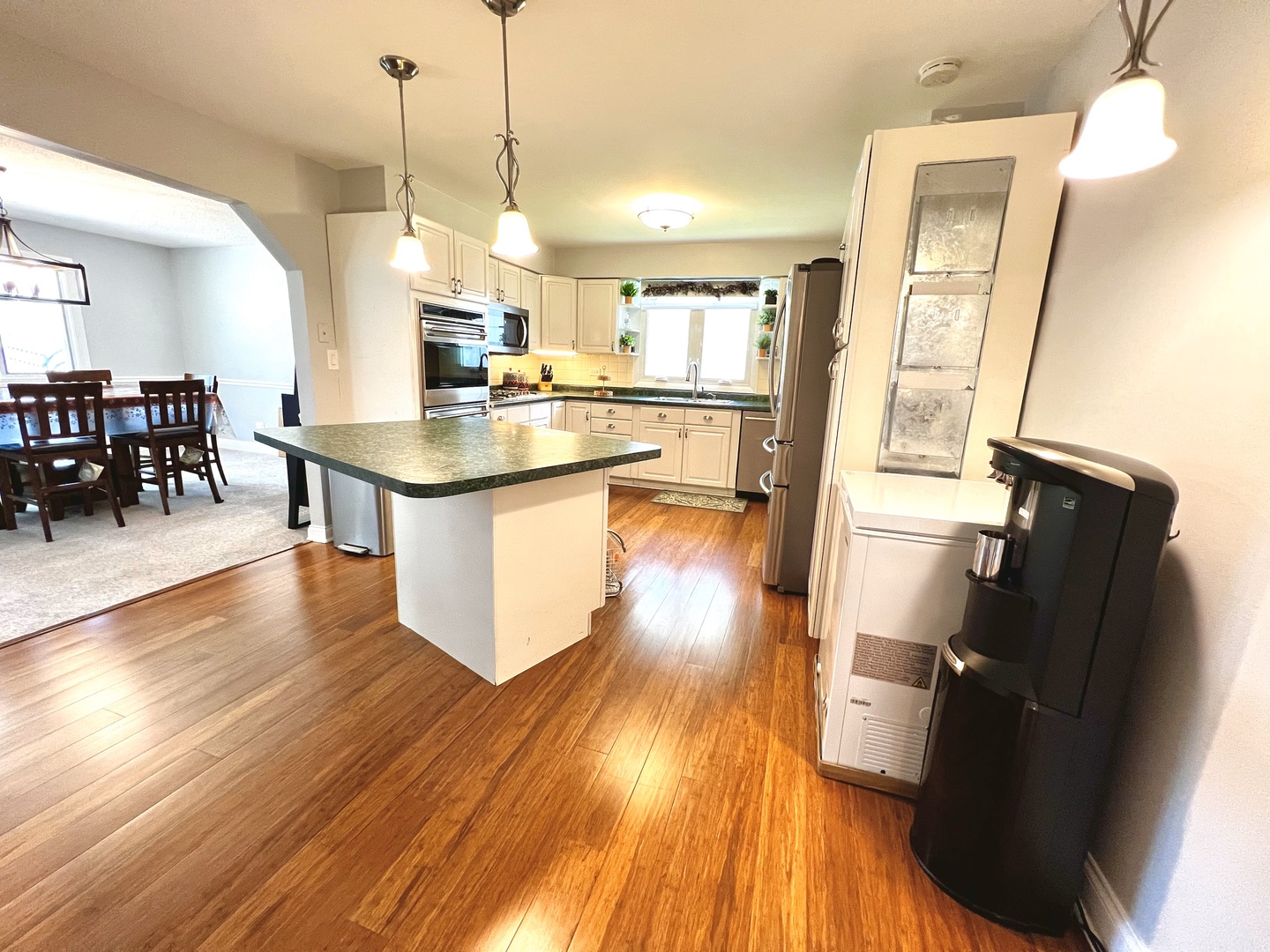 7125 Wirth Drive Darien, IL 60561 - Photo 12 of 38 a kitchen with stainless steel appliances granite countertop a refrigerator a sink dishwasher a stove and white countertops with wooden floor