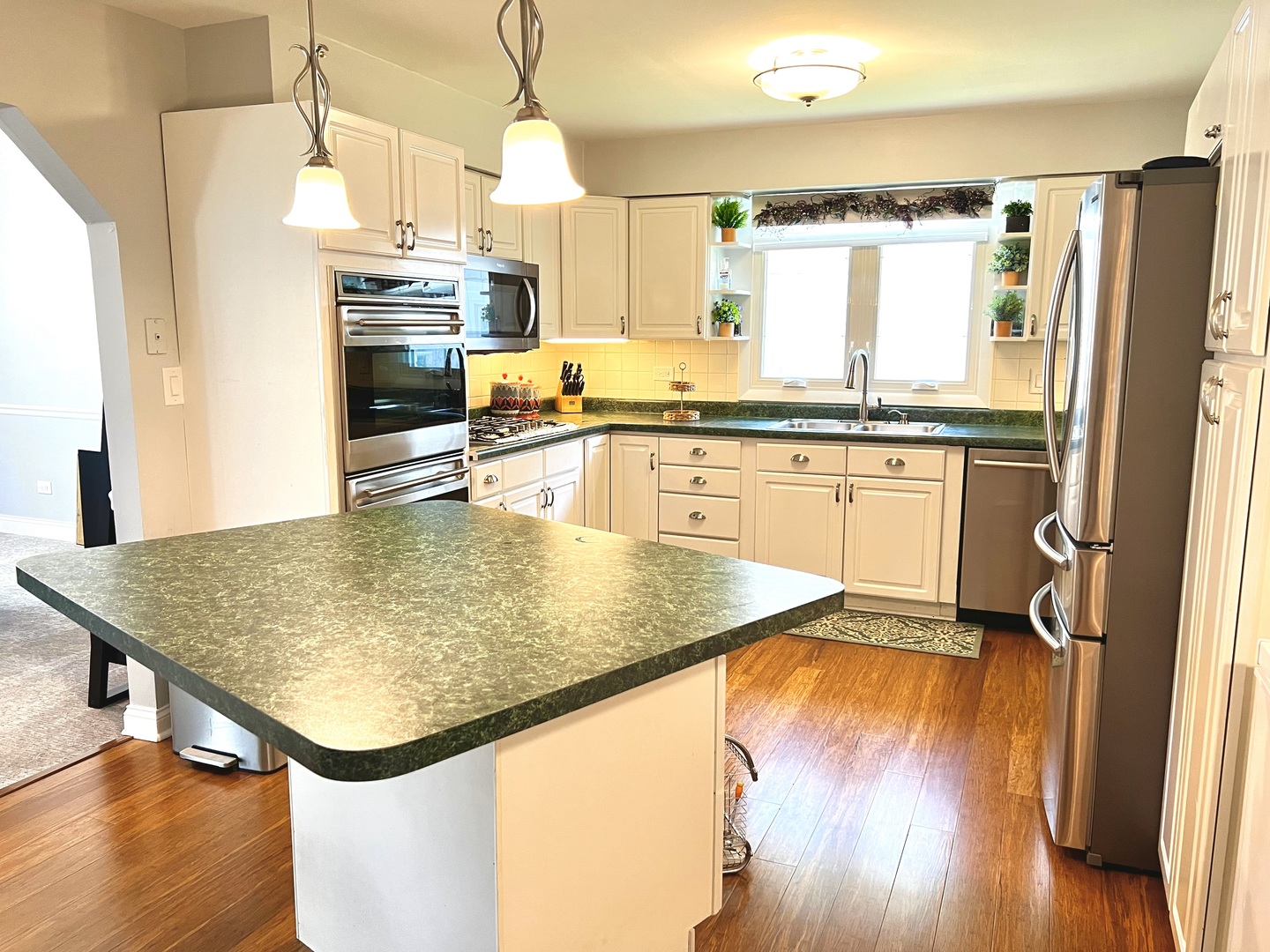 7125 Wirth Drive Darien, IL 60561 - Photo 13 of 38 a kitchen with stainless steel appliances granite countertop sink refrigerator and microwave