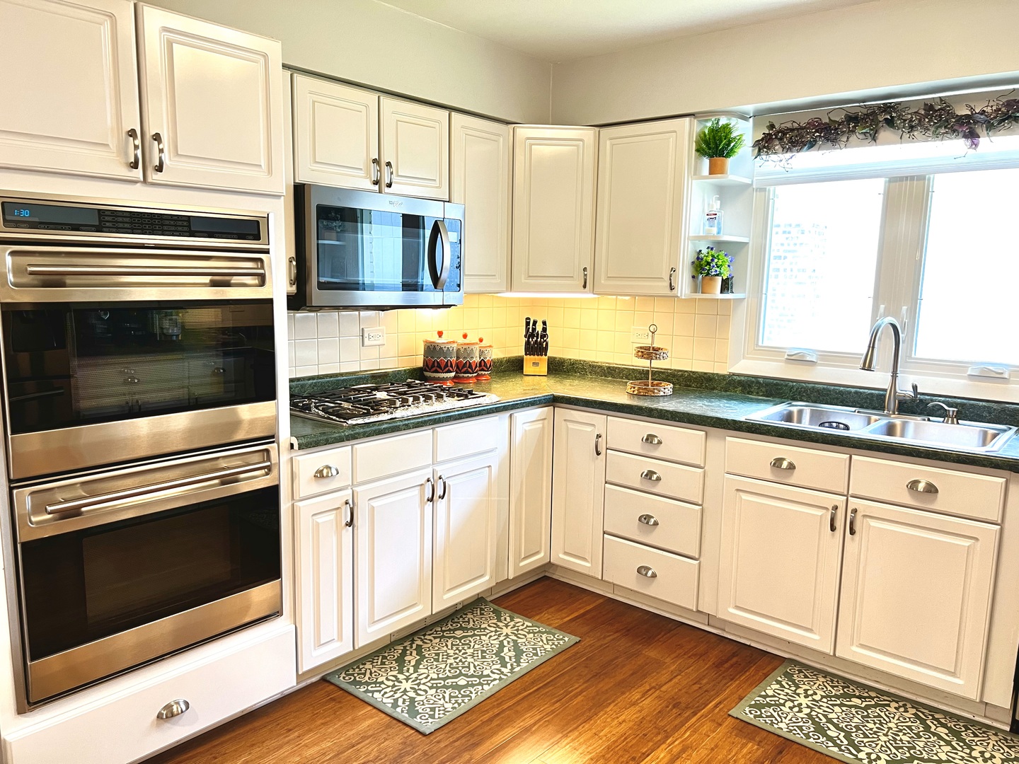 7125 Wirth Drive Darien, IL 60561 - Photo 14 of 38 a kitchen with granite countertop white cabinets stainless steel appliances and a sink