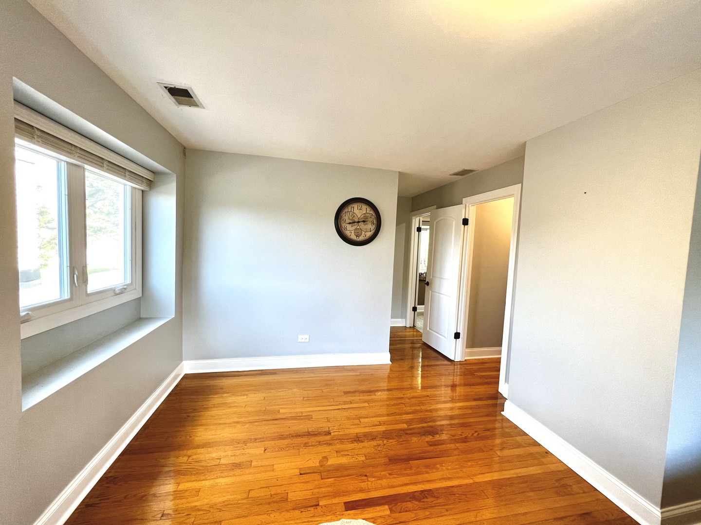 7125 Wirth Drive Darien, IL 60561 - Photo 20 of 38 a view of an empty room with wooden floor and a window