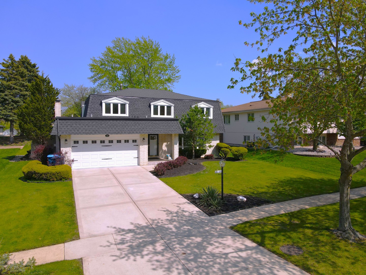 7125 Wirth Drive Darien, IL 60561 - Photo 2 of 38 a front view of a house with garden