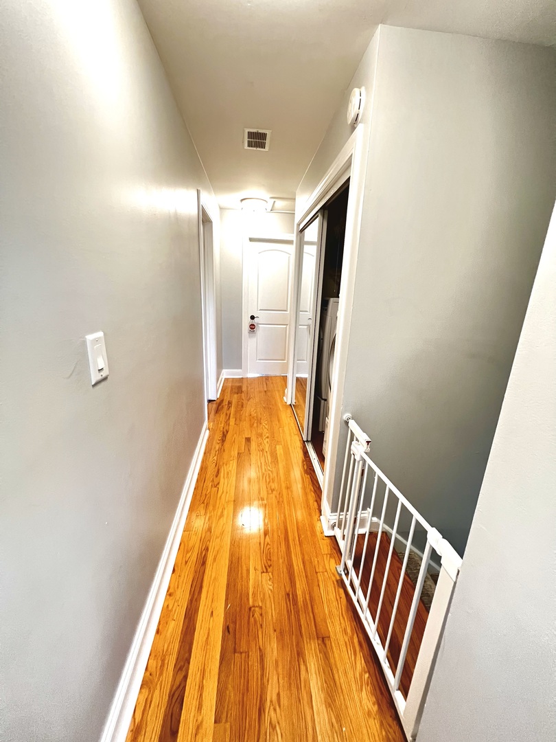 7125 Wirth Drive Darien, IL 60561 - Photo 7 of 38 a view of a hallway with wooden floor and staircase