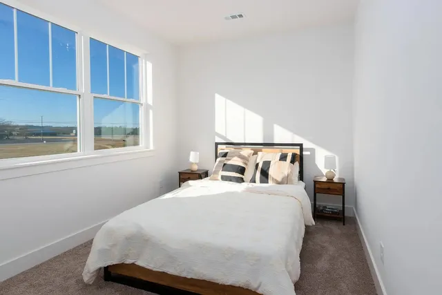 a bedroom with a bed and window