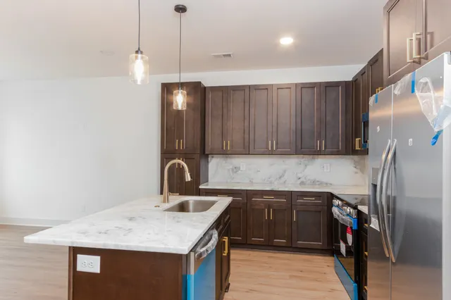 a kitchen with a sink and a refrigerator