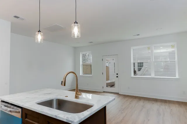 a view of a kitchen counter a sink and a stove