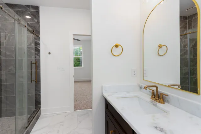 a bathroom with a sink vanity and a mirror