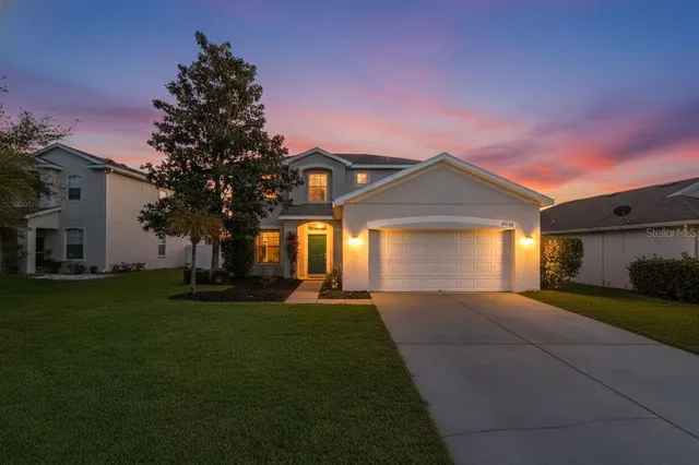 a front view of a house with a yard and garage