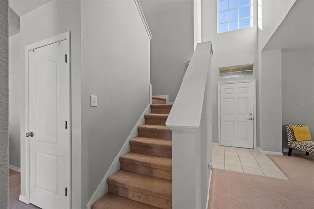 a kitchen with a refrigerator a stove a sink dishwasher with a dining table and chairs