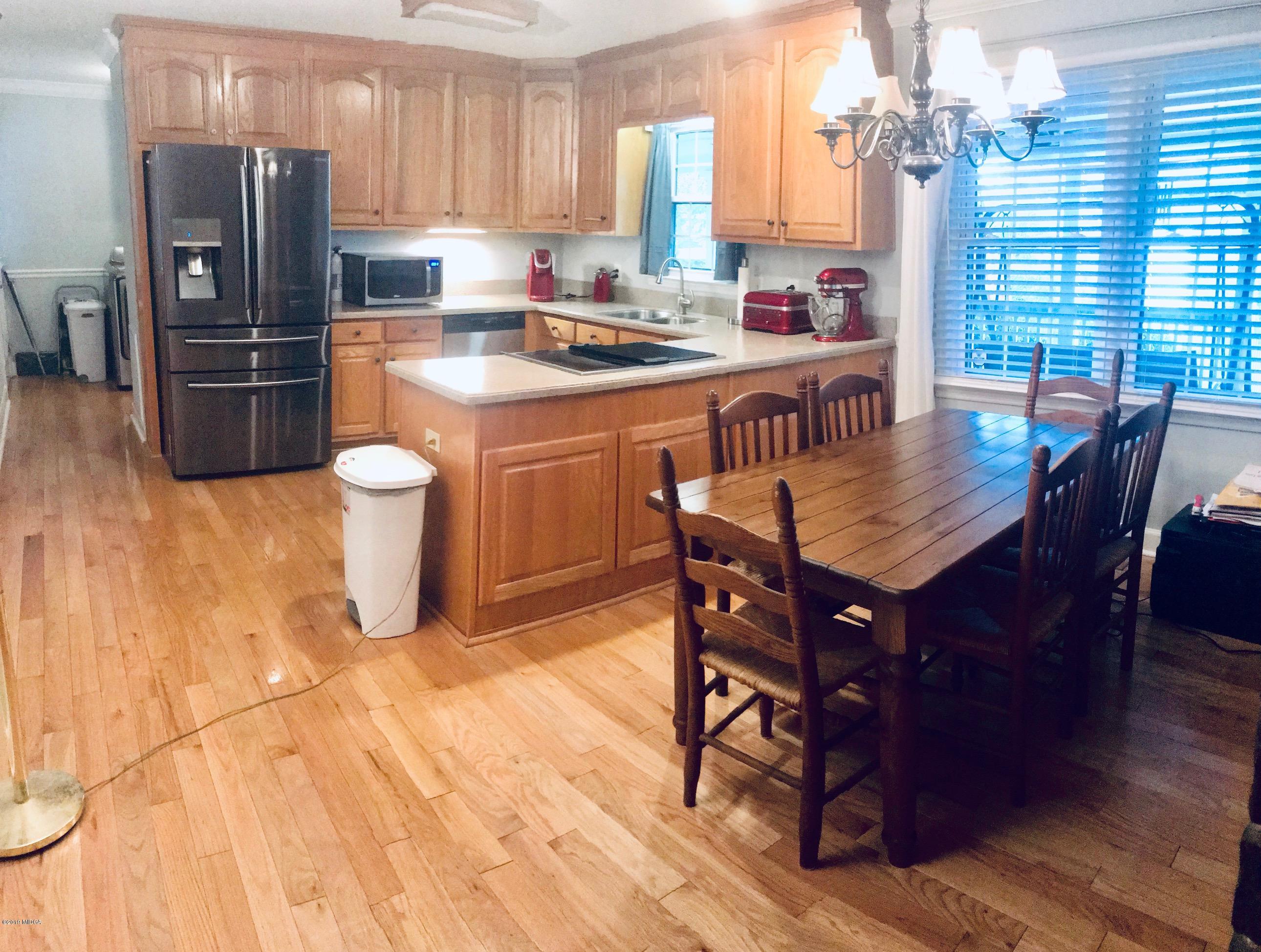 5838 School Road Macon, GA 31216 - Photo 11 of 33 a kitchen with stainless steel appliances granite countertop a dining table chairs stove refrigerator and cabinets