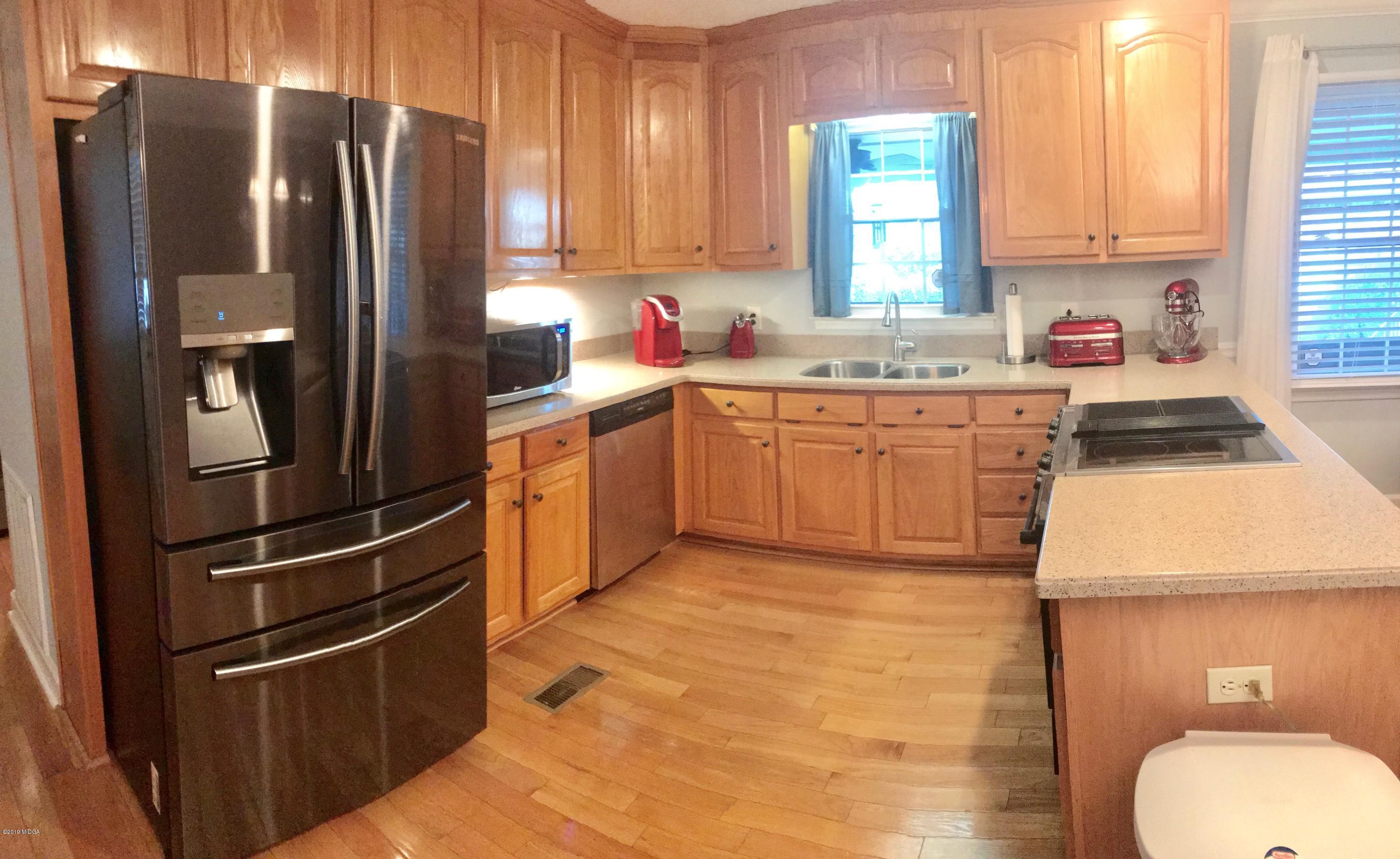 5838 School Road Macon, GA 31216 - Photo 13 of 33 a kitchen with granite countertop stainless steel appliances a refrigerator sink and microwave