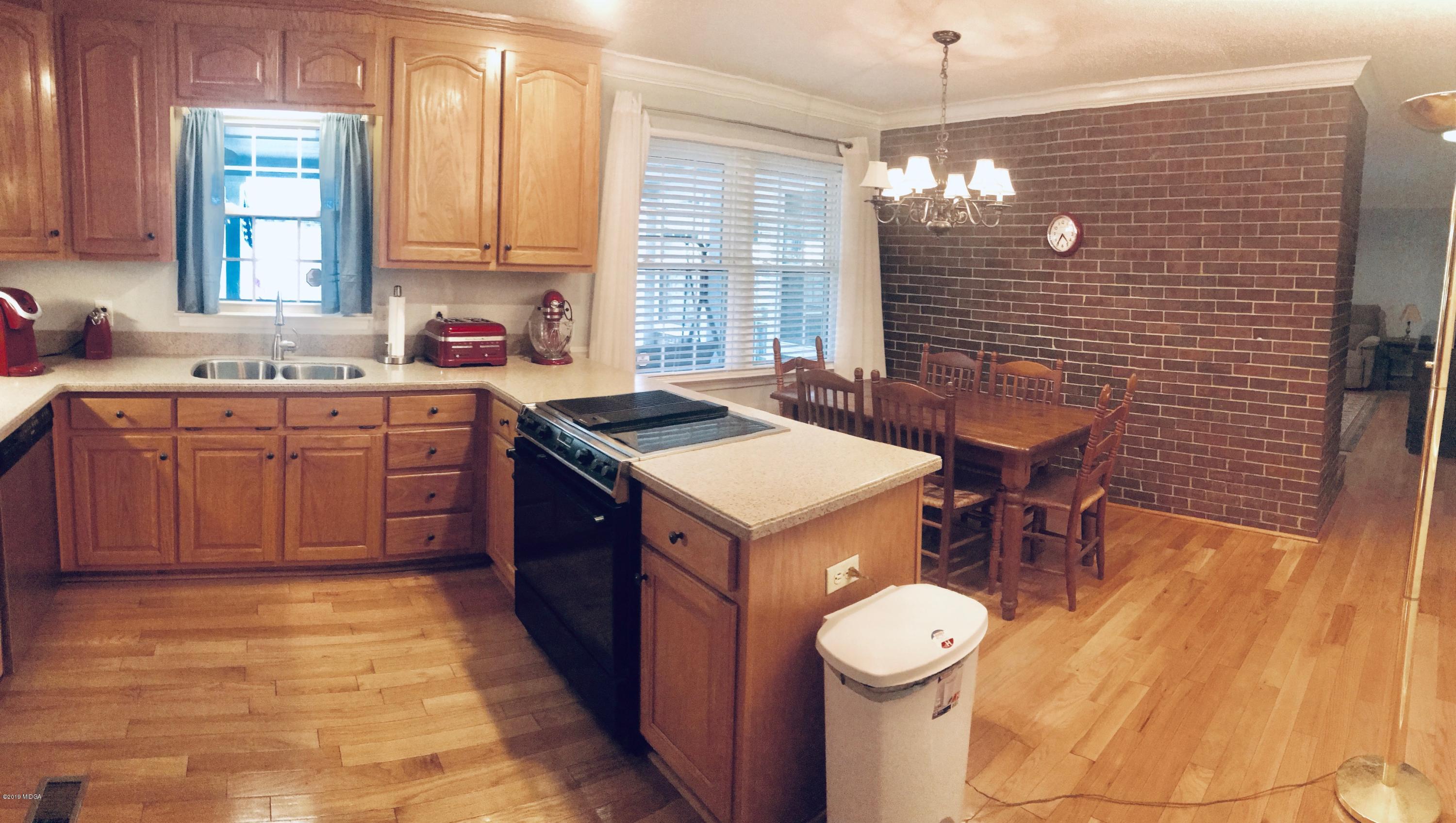 5838 School Road Macon, GA 31216 - Photo 15 of 33 a kitchen with a sink stove and cabinets