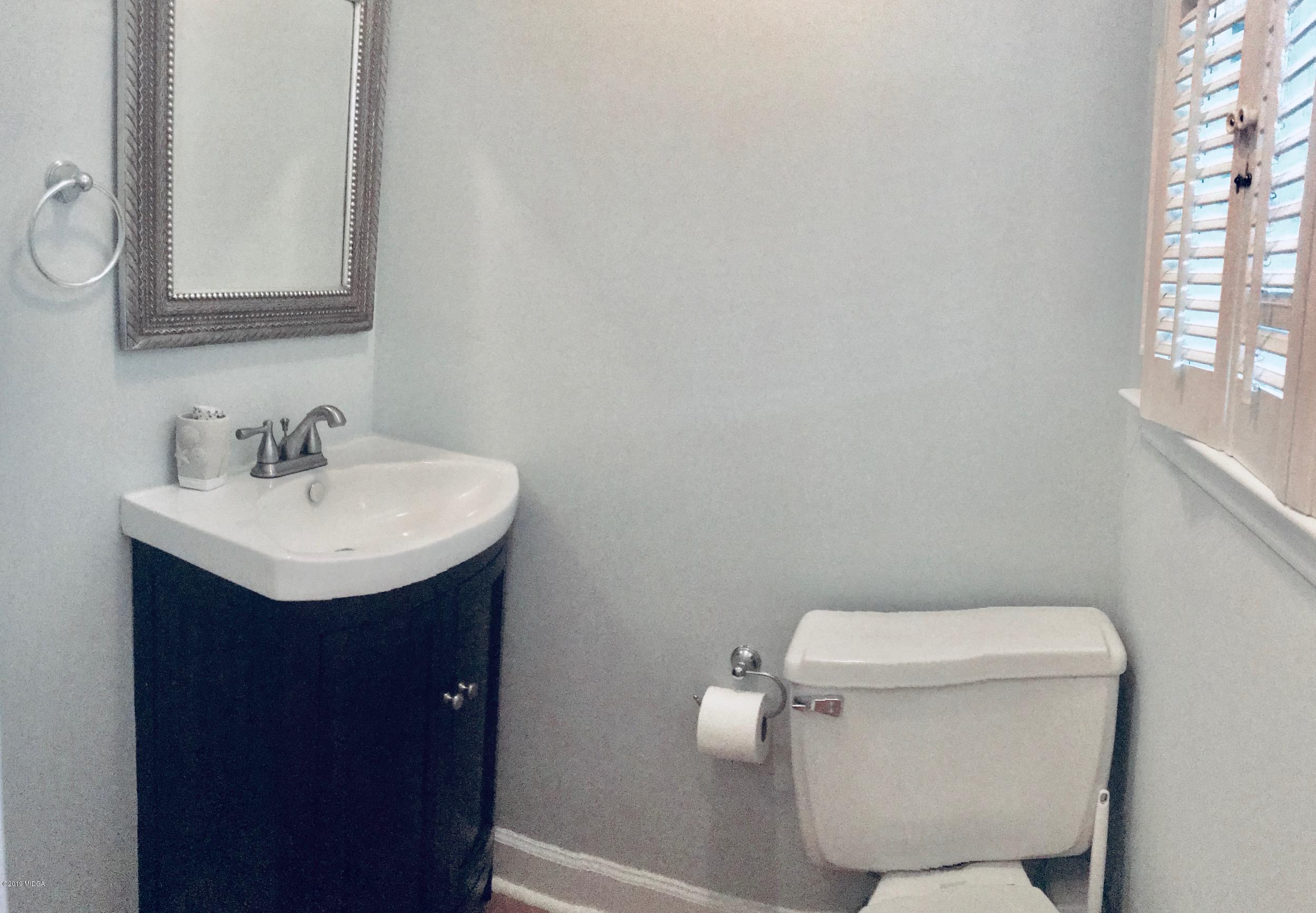 5838 School Road Macon, GA 31216 - Photo 17 of 33 a bathroom with a sink toilet and a window