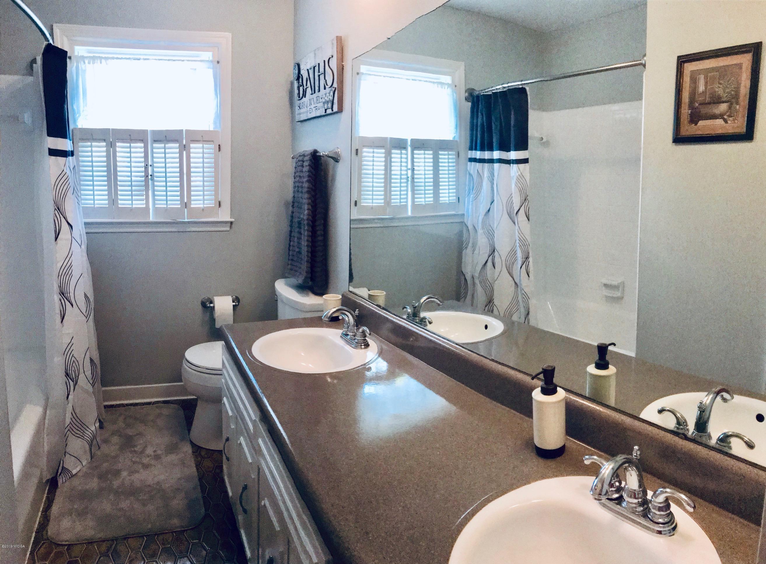 5838 School Road Macon, GA 31216 - Photo 26 of 33 a bathroom with a sink double vanity and a mirror