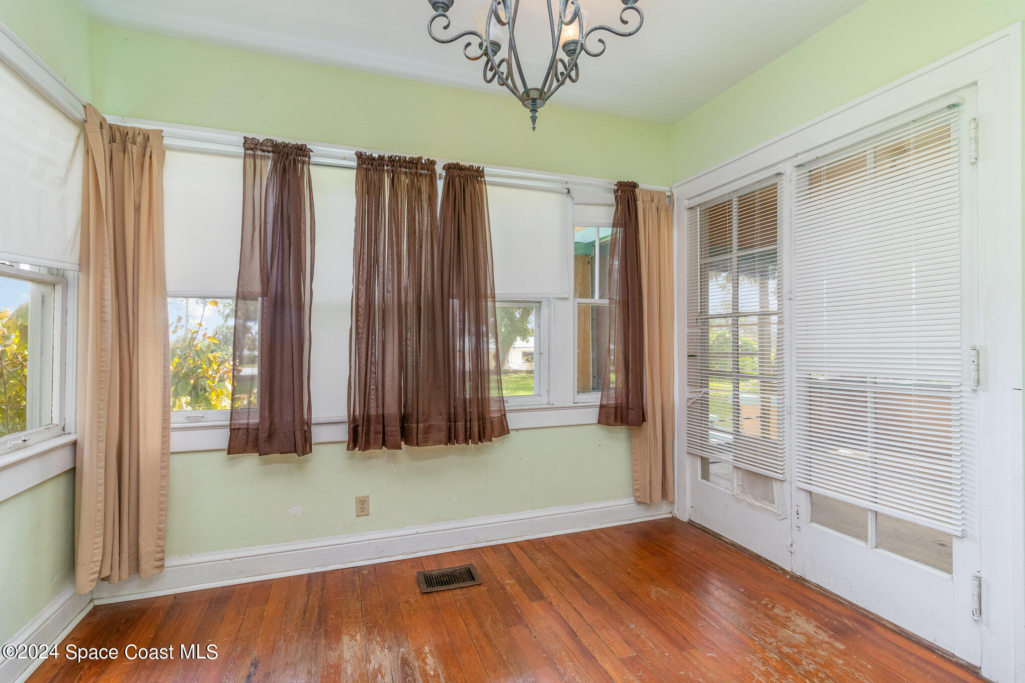 1632 Water Drive Northeast Palm Bay, FL 32905 - Photo 21 of 31 a view of a room with a large window and wooden floor
