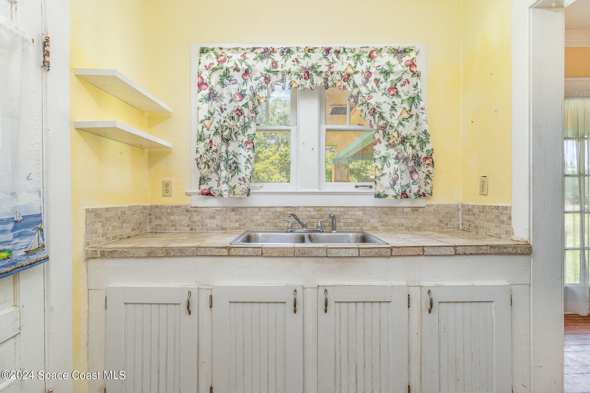 1632 Water Drive Northeast Palm Bay, FL 32905 - Photo 23 of 31 a bathroom with a granite countertop sink and a mirror