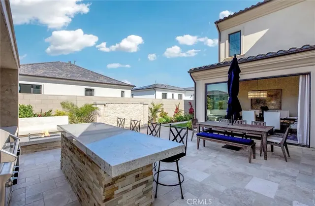 a view of a patio with table and chairs