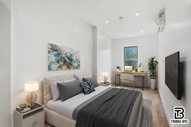 a bedroom with furniture and a flat screen tv