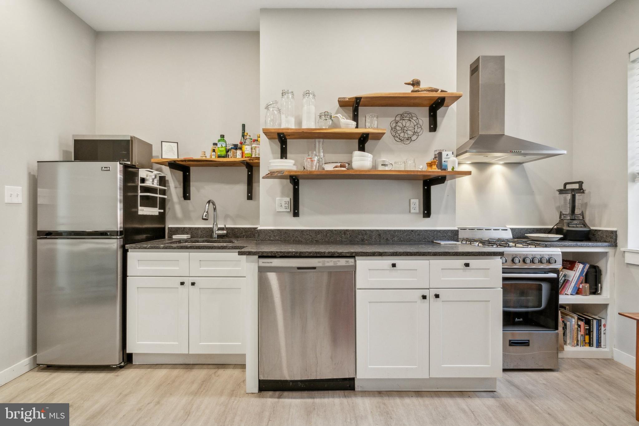 2006 Pine Street, Unit 2 Philadelphia, PA 19103 - Photo 6 of 12 a kitchen with stainless steel appliances granite countertop a stove and a refrigerator
