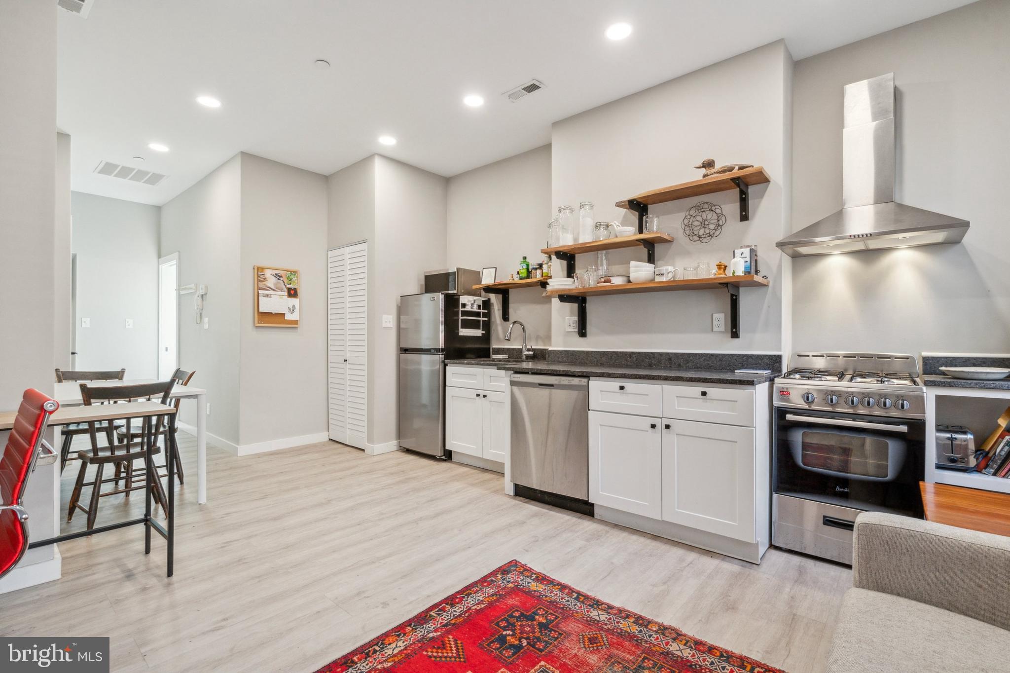 2006 Pine Street, Unit 2 Philadelphia, PA 19103 - Photo 7 of 12 a kitchen with cabinets and wooden floor