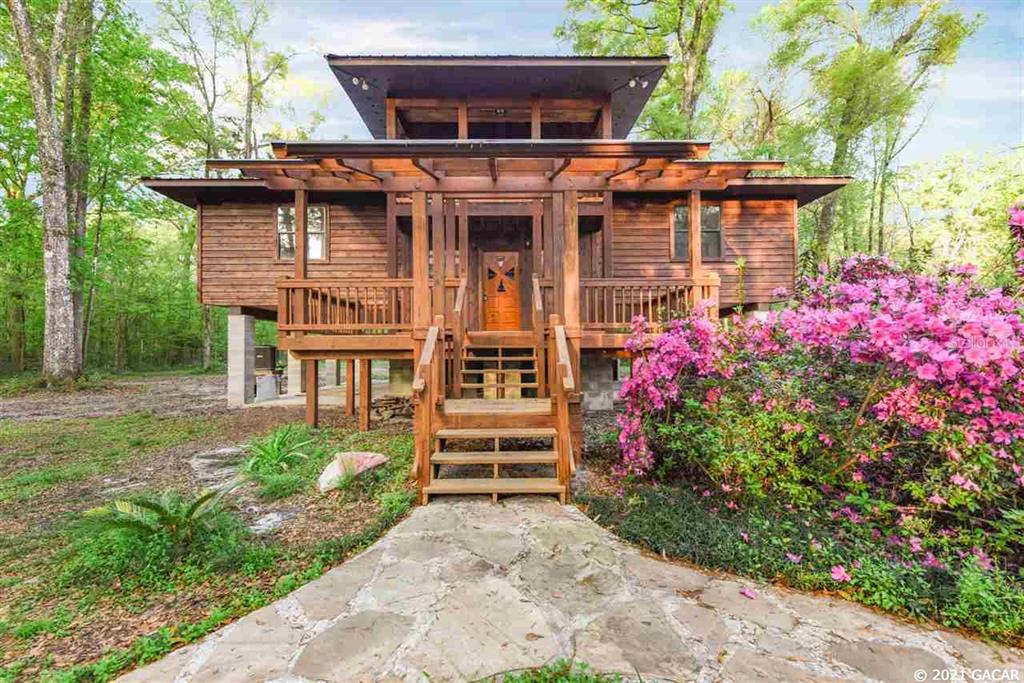 a front view of a house with a garden