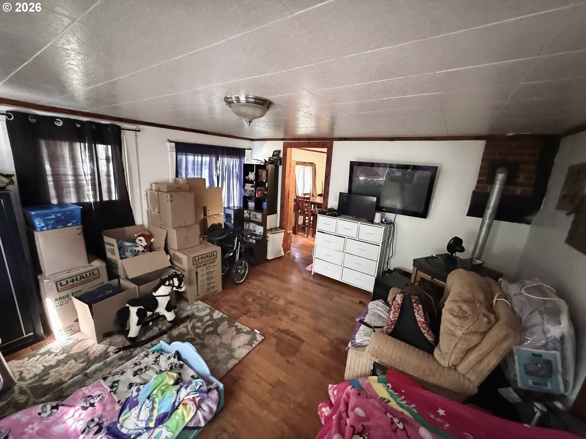 827 East 11th Street Coquille, OR 97423 - Photo 27 of 45 a living room with furniture and a flat screen tv