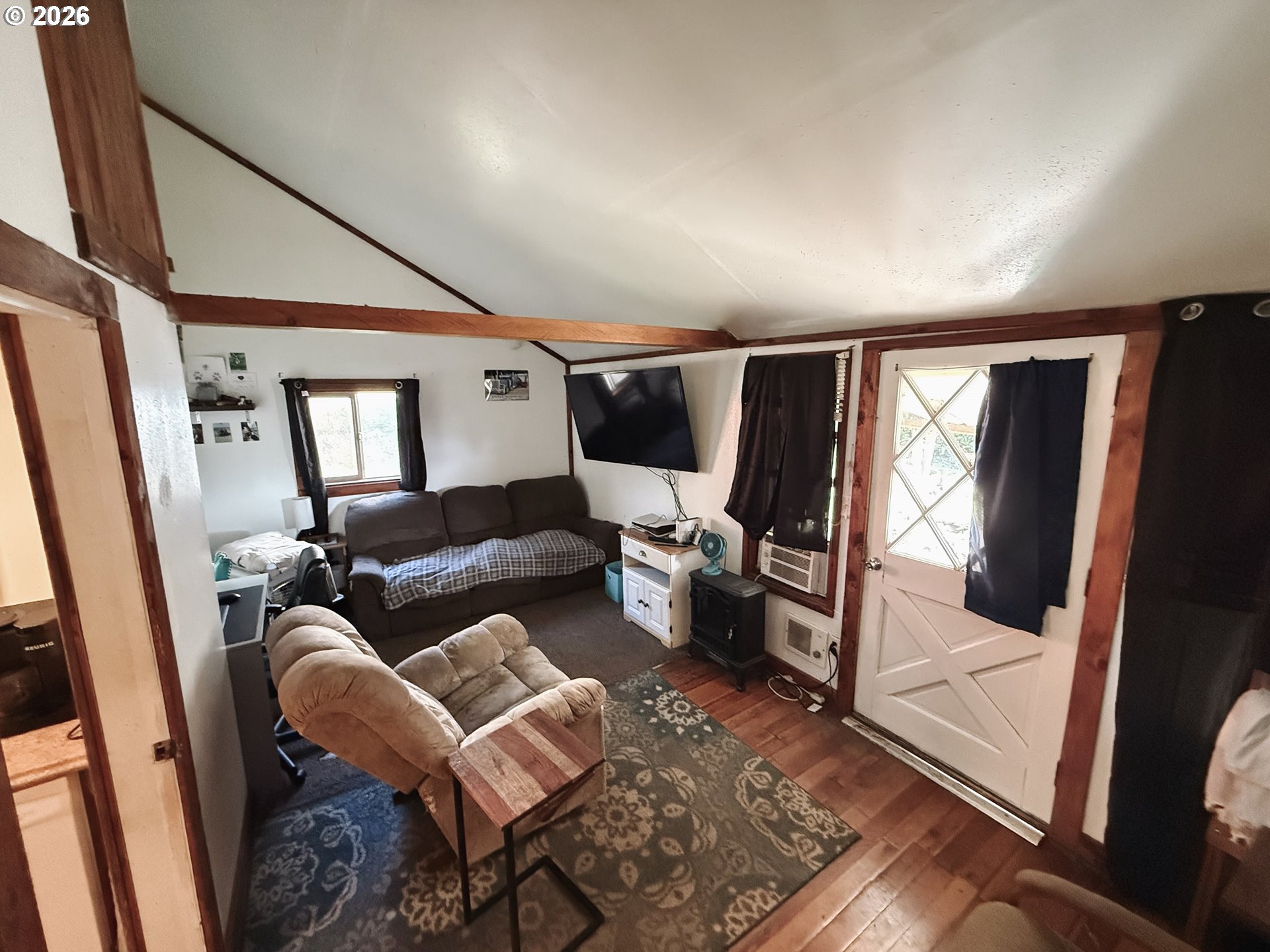 827 East 11th Street Coquille, OR 97423 - Photo 31 of 45 a living room with furniture and a flat screen tv