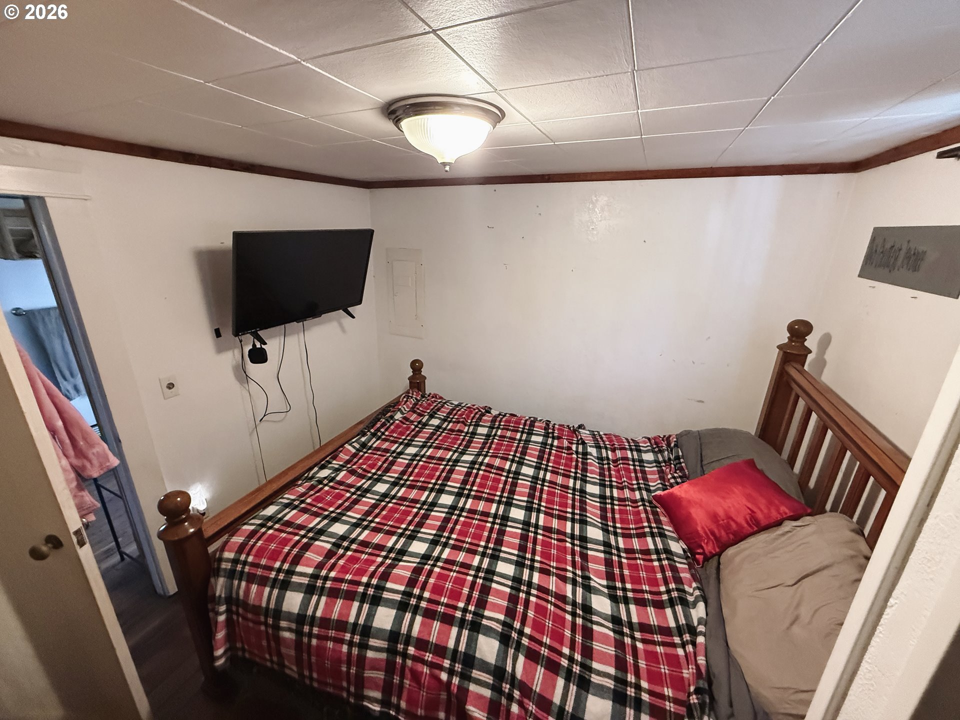 827 East 11th Street Coquille, OR 97423 - Photo 41 of 45 a bedroom with a bed and flat screen tv