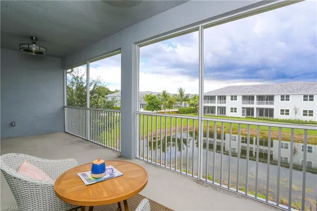 a view of a balcony that has two chairs and a table