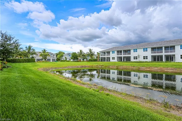 a view of a house with a big yard and sitting area