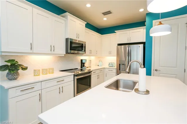 a kitchen with a sink a stove and refrigerator