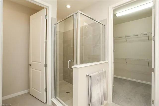 a bathroom with a glass shower door