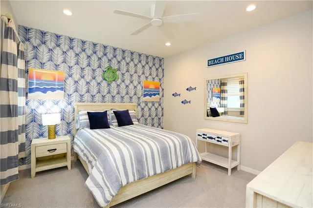 a bedroom with a bed and a wall painting