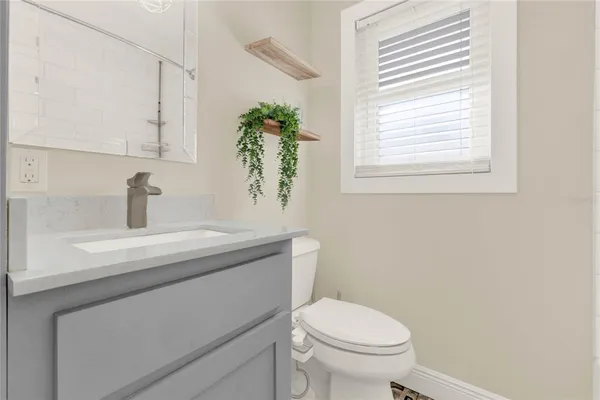 a bathroom with a toilet a sink and a window