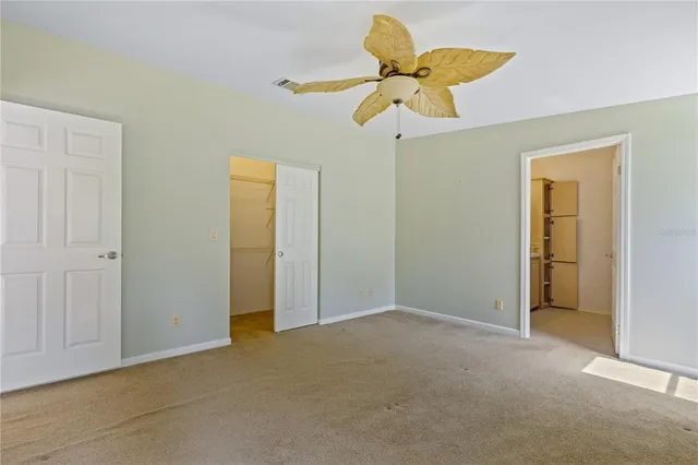a kitchen with a sink dishwasher a stove and white cabinets with wooden floor